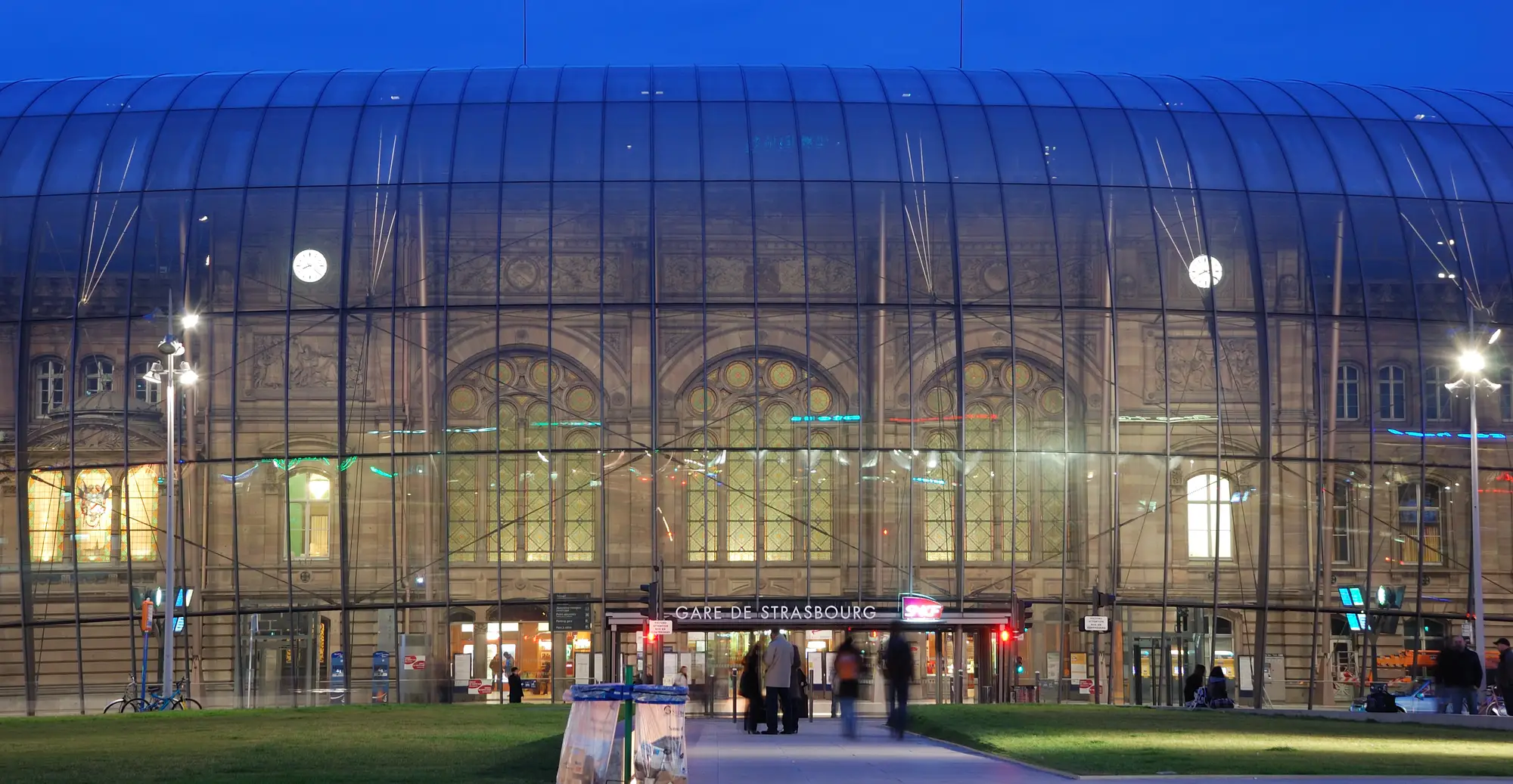 Strasbourg station at dusk, its glass shell set in front of the 1883 sandstone facade